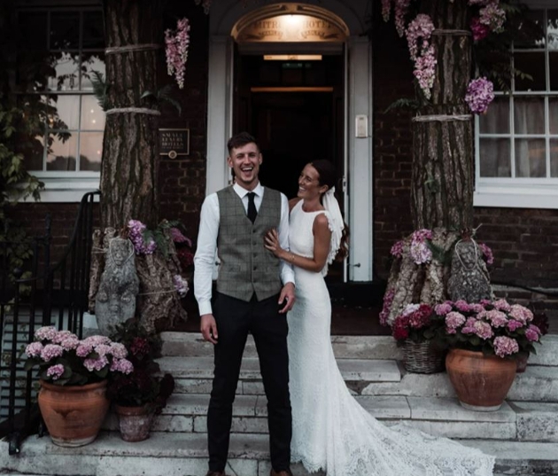 wedding couple on steps of building 