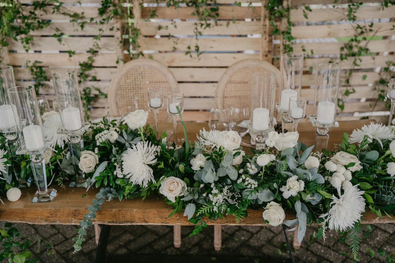 wedding reception top table rustic look with floral display