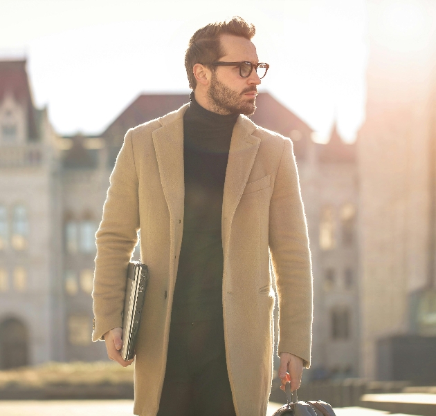 man in glasses and brown jacket side profile