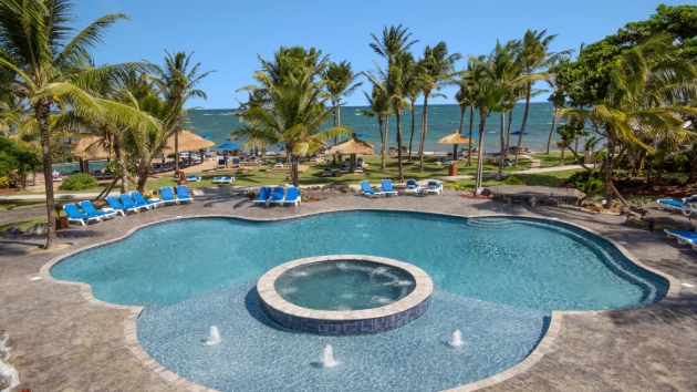 curved pool with spa pool in centre looking out to sea